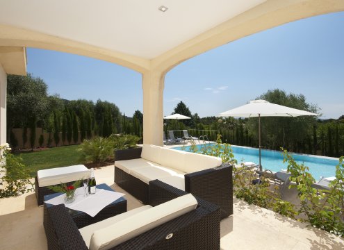 Gemütliche Sitzecke auf der überdachten Terrasse mit hochwertigen Loungemöbeln