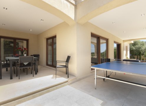 Sitzgruppe auf der überdachten Terrasse und Tischtennisplatte für den Familienspaß